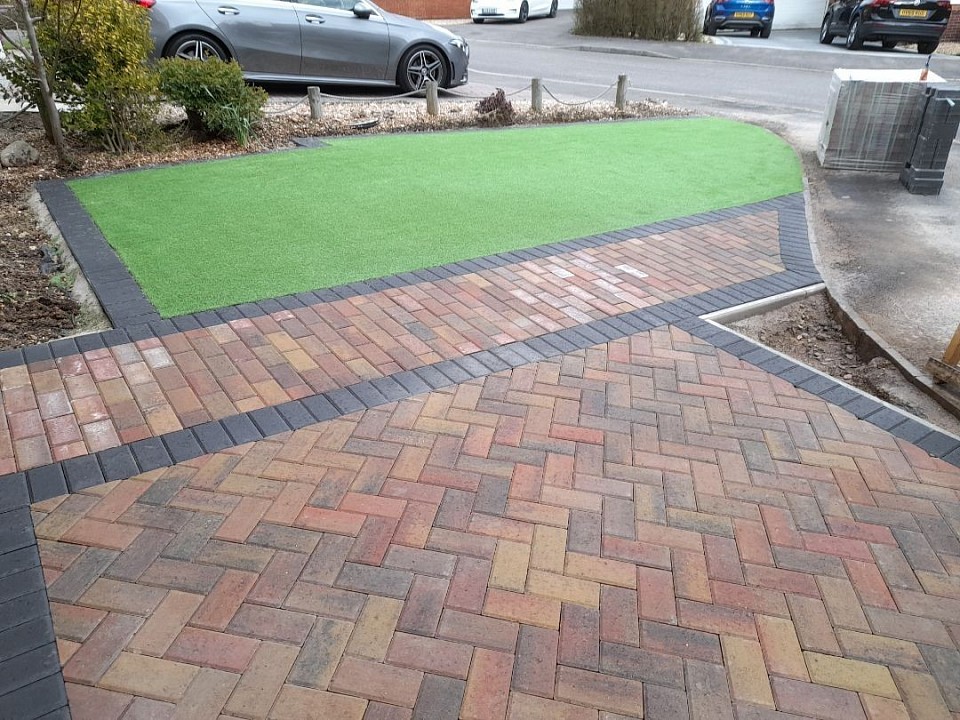 Block paved driveway with artificial grass