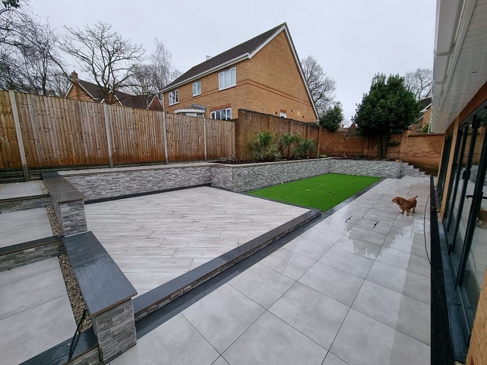 Fully landscaped garden in Whiteley using porcelain paving, wall cladding and artificial grass