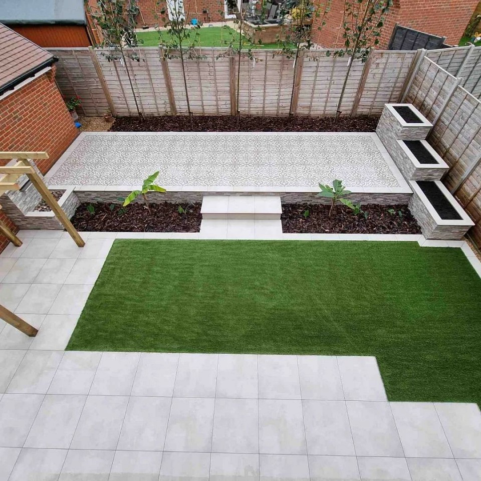 Fully landscaped garden in Curbridge, Whiteley, Hampshire. We used porcelain paving block wall planters with stone cladding and artificial grass