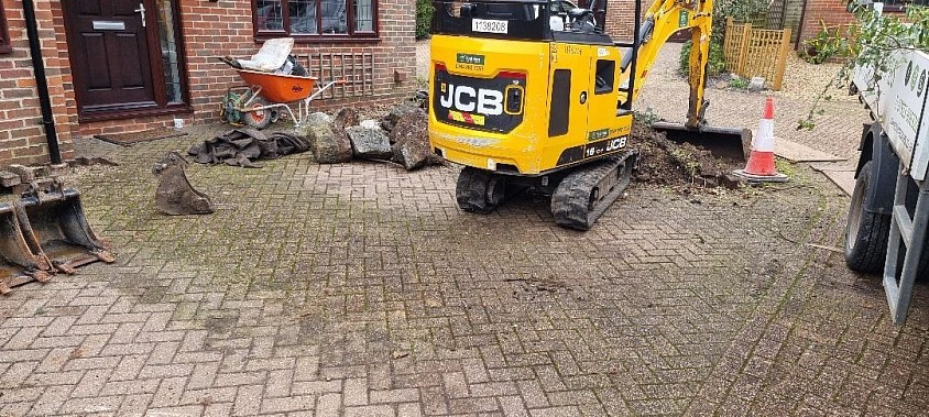 Excavate a tired old driveway.